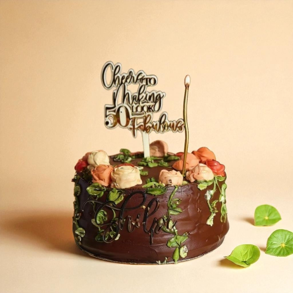 Chocolate cake with floral, forest decorations and a birthday candle on a beige background